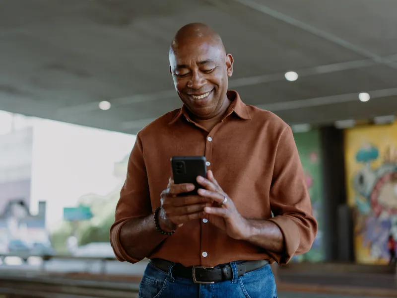 Mature man holding smartphone