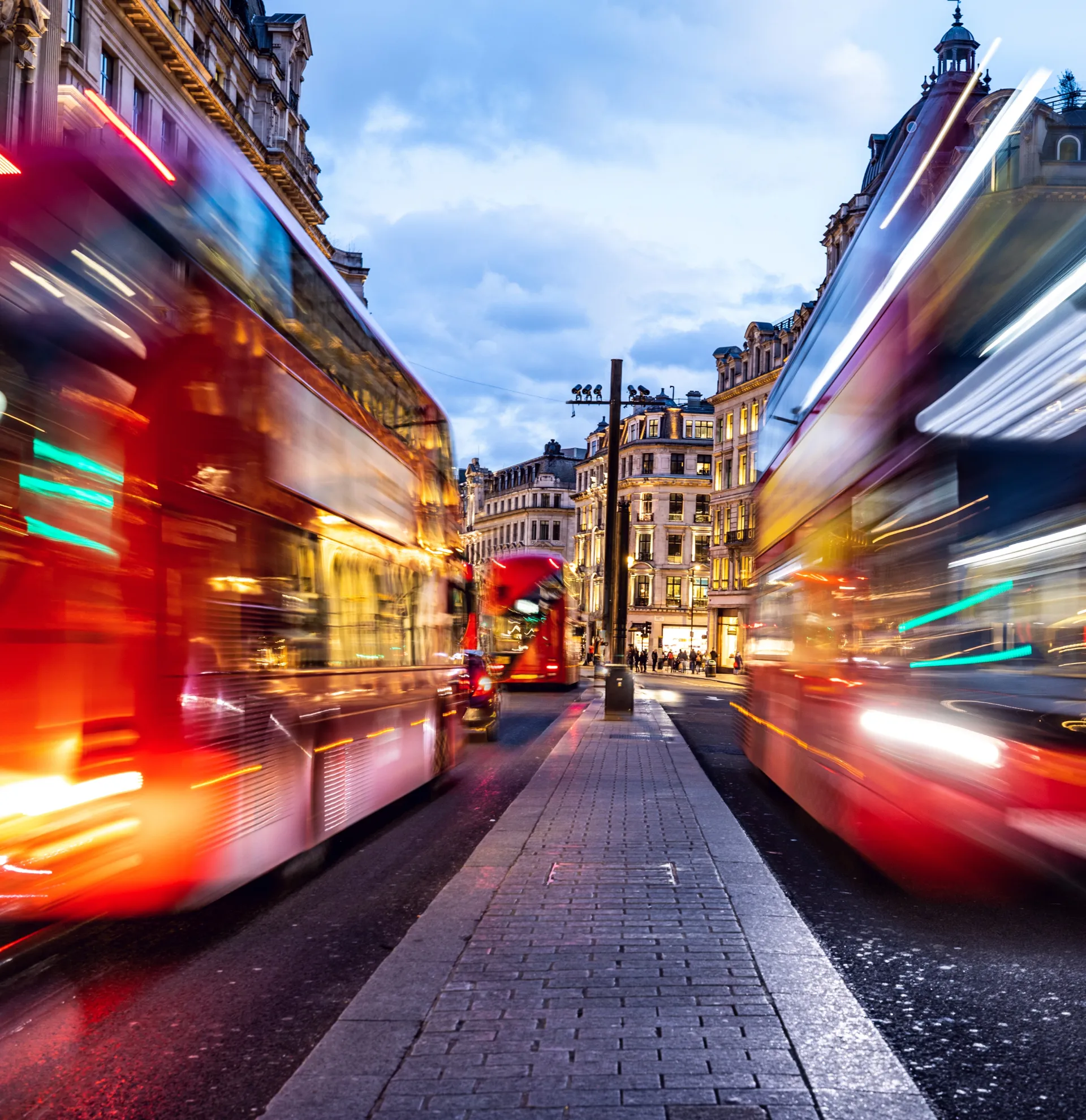 london typical red bus blurred motion at night 1139730118 1920x1980