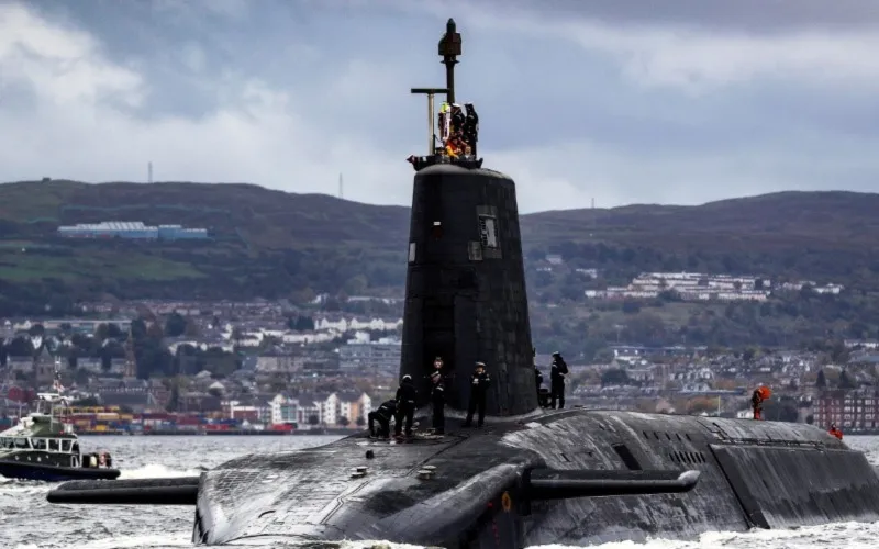 submarine-surfacing-with-crew-on-deck-near-coastal-town