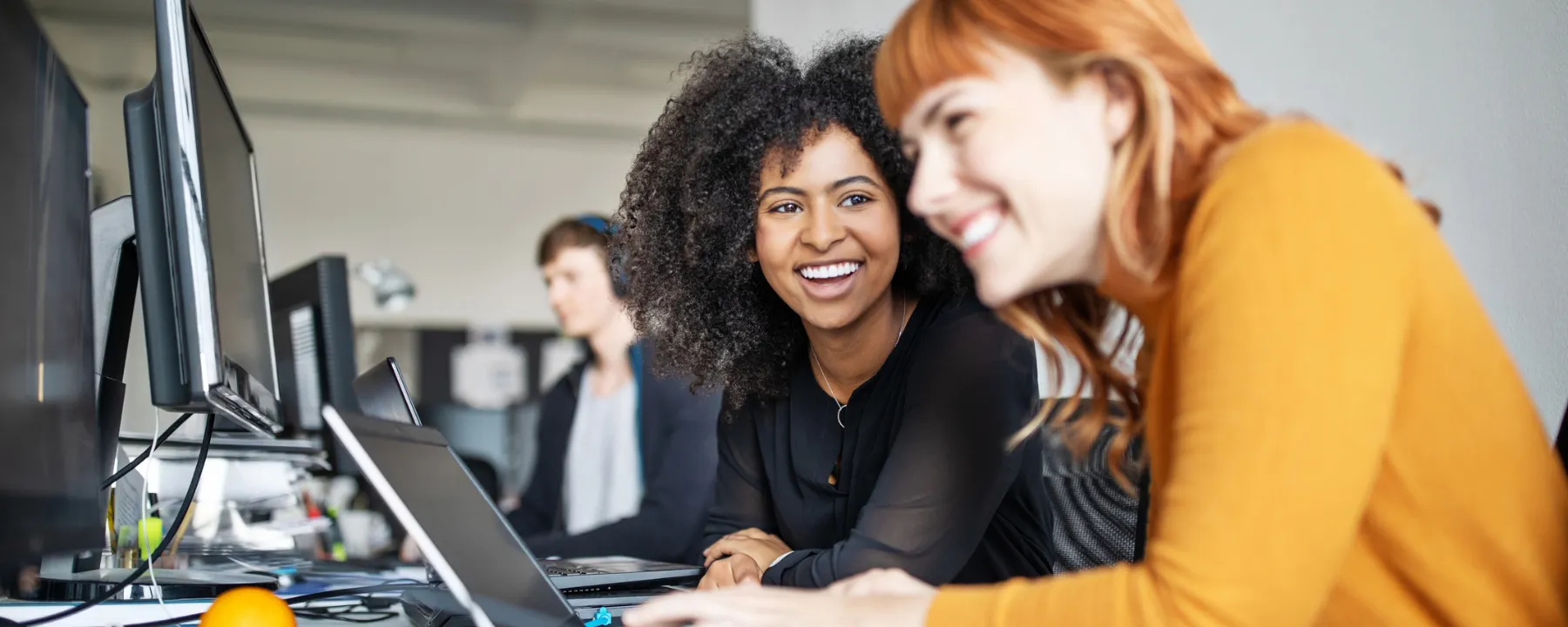 Two female colleagues in office working together